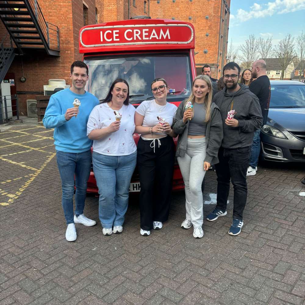 The team in front of an ice cream van enjoying ice cream